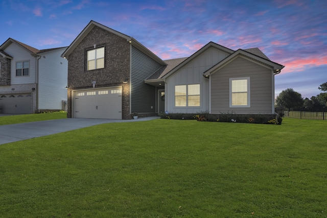 view of front of property with a lawn and a garage