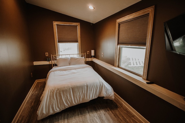 bedroom featuring hardwood / wood-style floors and lofted ceiling