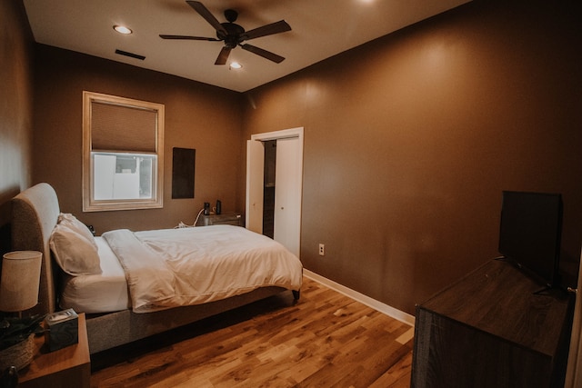 bedroom with ceiling fan and hardwood / wood-style flooring