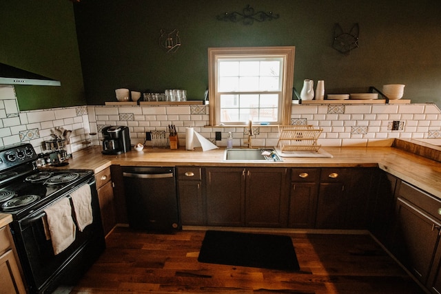 kitchen with sink, wood counters, black electric range, stainless steel dishwasher, and extractor fan