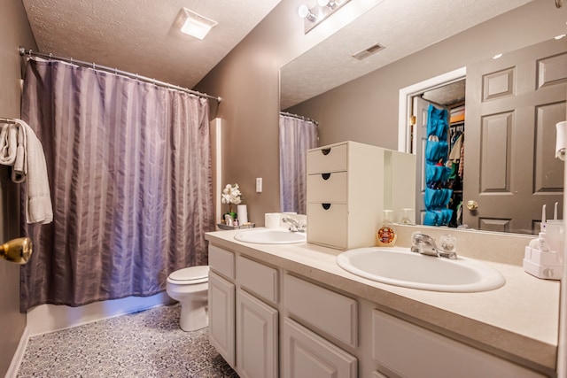 full bathroom with shower / bathtub combination with curtain, vanity, a textured ceiling, and toilet