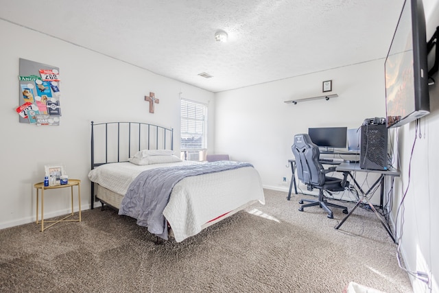 carpeted bedroom featuring a textured ceiling