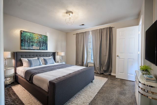 bedroom with dark colored carpet