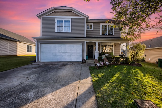 view of property featuring a garage and a yard