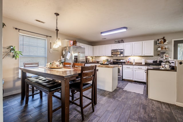 dining room with sink and dark wood-type flooring