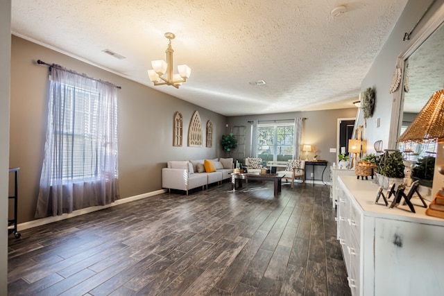 living room with a notable chandelier, dark hardwood / wood-style flooring, and a textured ceiling