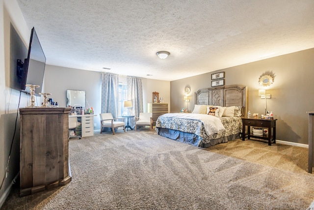 bedroom featuring carpet flooring and a textured ceiling