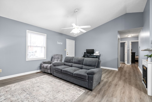 living room with hardwood / wood-style floors, ceiling fan, and lofted ceiling