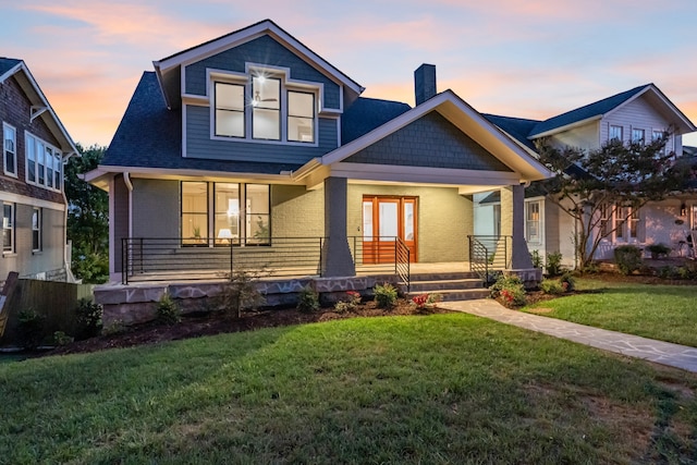 craftsman-style house with a yard and a porch