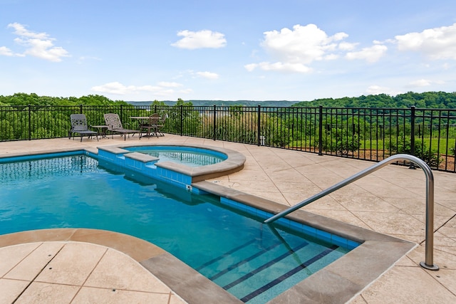 view of swimming pool with an in ground hot tub and a patio