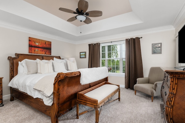 bedroom featuring a raised ceiling, ceiling fan, crown molding, and light carpet