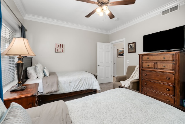 carpeted bedroom with ceiling fan and ornamental molding