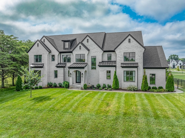 french provincial home featuring a front yard