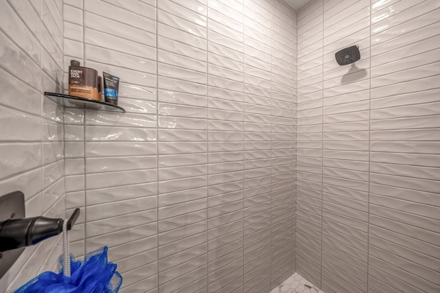 bathroom with tiled shower