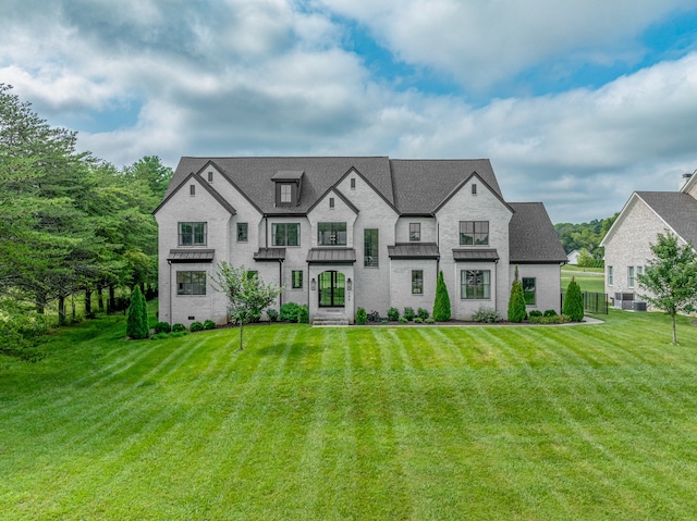 french country style house with a front yard