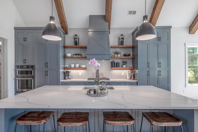 kitchen featuring a breakfast bar, stainless steel double oven, light stone countertops, and backsplash