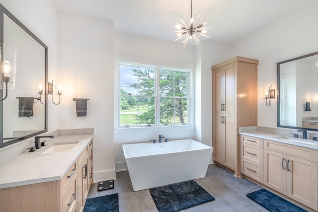 bathroom featuring a tub to relax in, hardwood / wood-style floors, vanity, and a chandelier