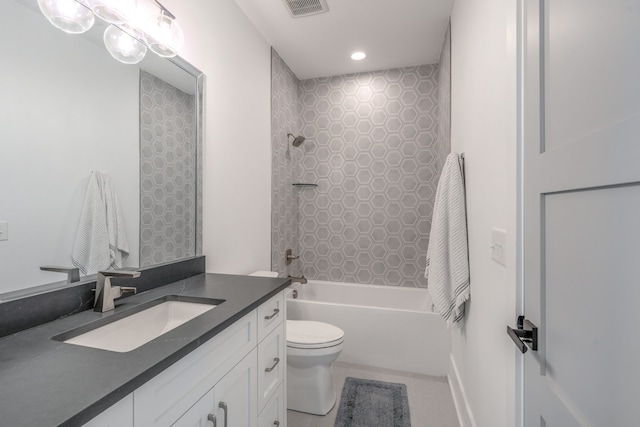 full bathroom featuring vanity, toilet, and tiled shower / bath