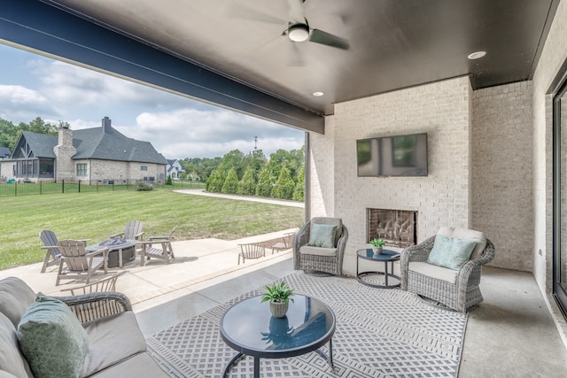 view of patio with ceiling fan and an outdoor fire pit