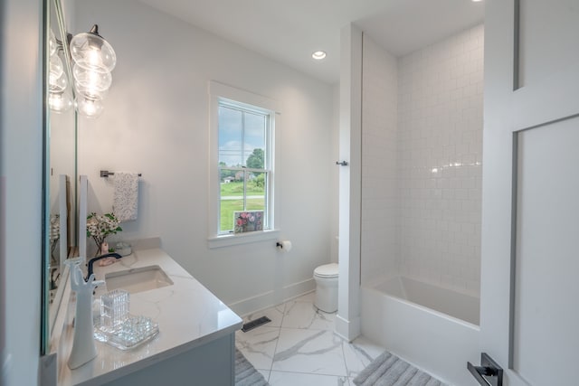 full bathroom with tiled shower / bath, vanity, and toilet