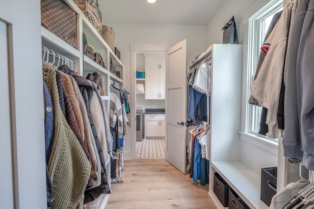 walk in closet with light wood-type flooring