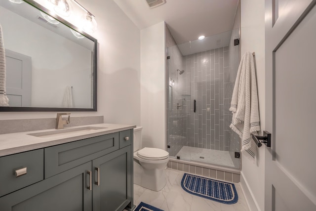 bathroom with a shower with door, vanity, and toilet