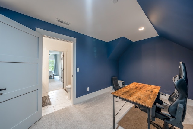 office space featuring light colored carpet and vaulted ceiling