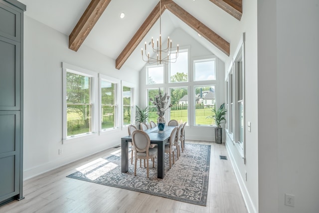 sunroom / solarium featuring vaulted ceiling with beams and an inviting chandelier