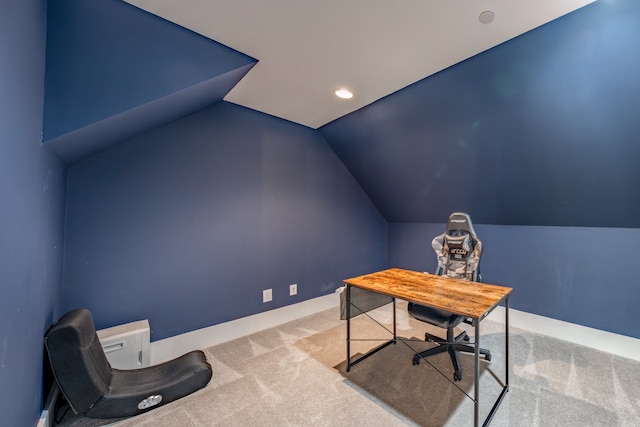 carpeted office space featuring lofted ceiling