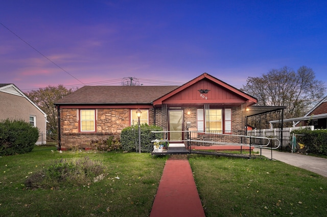 view of front of property featuring a yard and a carport