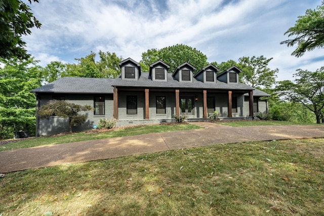 cape cod house featuring covered porch and a front yard