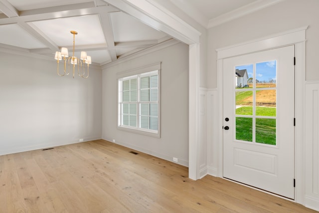 foyer entrance with a notable chandelier, beamed ceiling, coffered ceiling, and light wood-type flooring