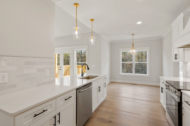 kitchen with a wealth of natural light, sink, white cabinets, and stainless steel appliances