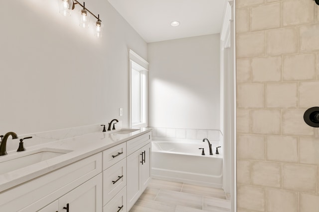 bathroom with a bath and vanity