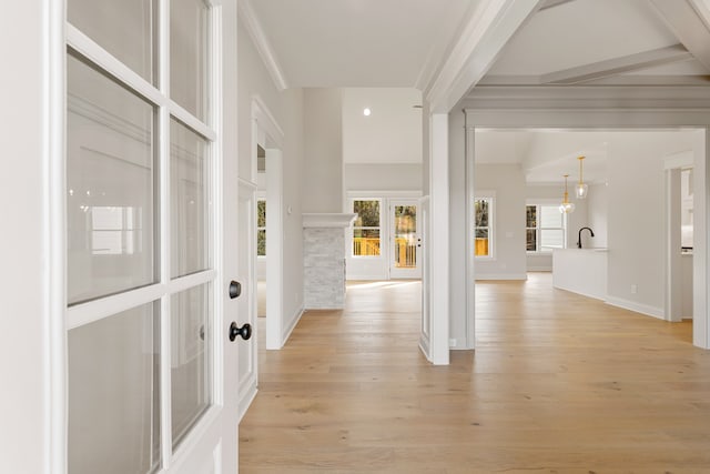 entryway featuring a fireplace, light hardwood / wood-style flooring, and crown molding