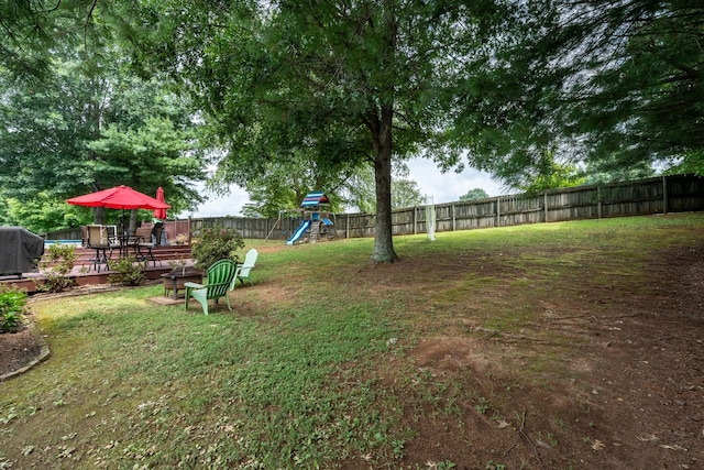 view of yard with a playground and a wooden deck