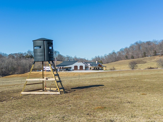 view of playground featuring a yard and a rural view