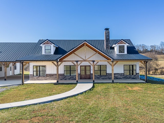 back of property with a lawn and french doors