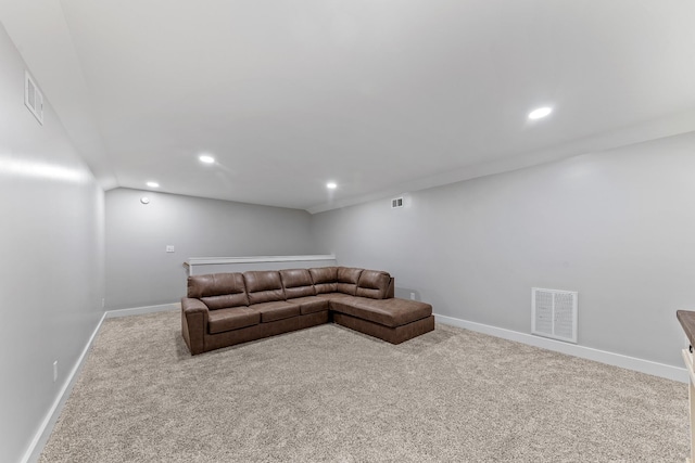 carpeted living room with vaulted ceiling