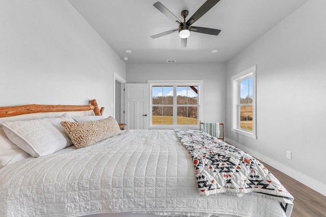 bedroom with ceiling fan and dark hardwood / wood-style floors