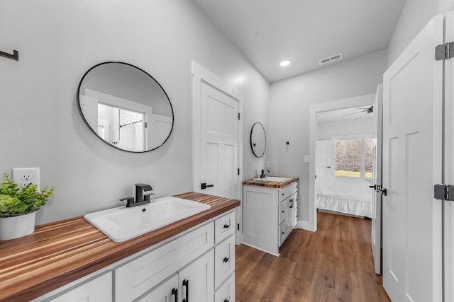 bathroom with ceiling fan, wood-type flooring, and vanity