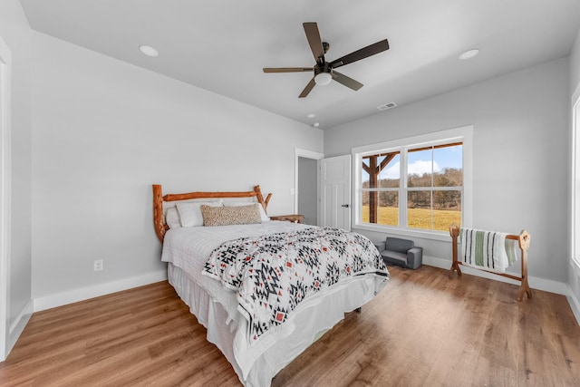 bedroom with ceiling fan and hardwood / wood-style floors