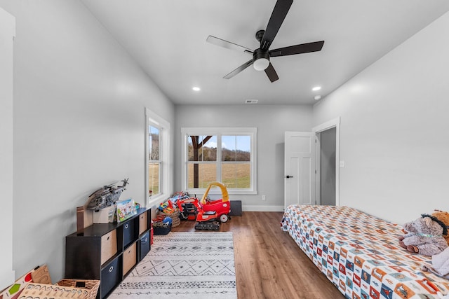 bedroom with ceiling fan and hardwood / wood-style floors