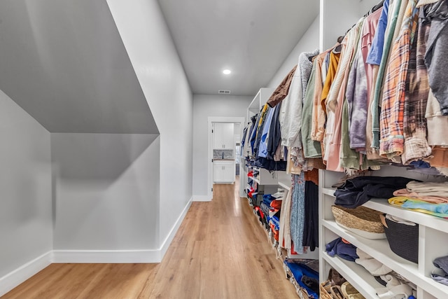 spacious closet featuring light hardwood / wood-style flooring