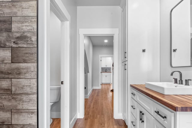 bathroom featuring hardwood / wood-style floors, toilet, and vanity