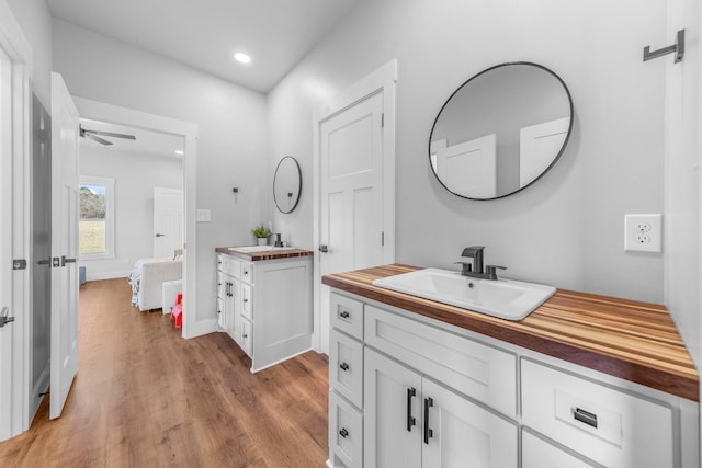 bathroom featuring ceiling fan, wood-type flooring, and vanity