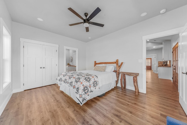 bedroom with ceiling fan, a closet, and light hardwood / wood-style floors