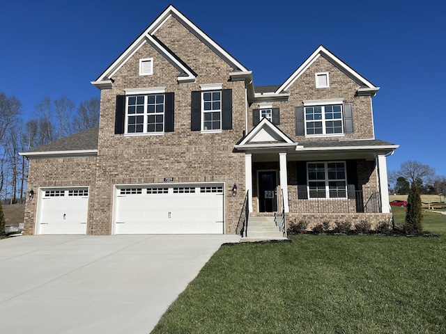 craftsman-style home with covered porch, a garage, and a front yard