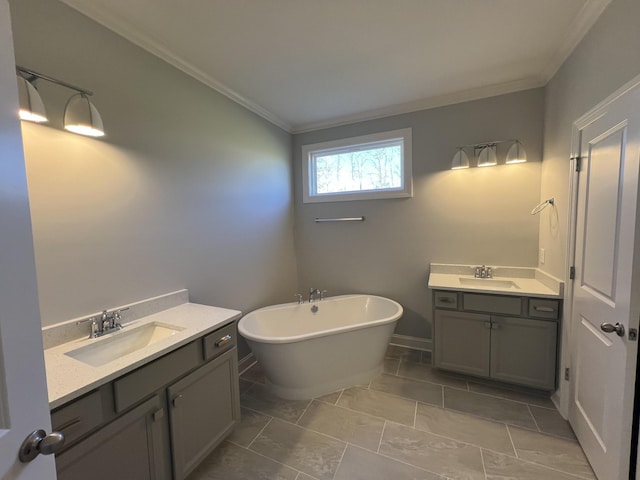 bathroom featuring a bathing tub, crown molding, and vanity