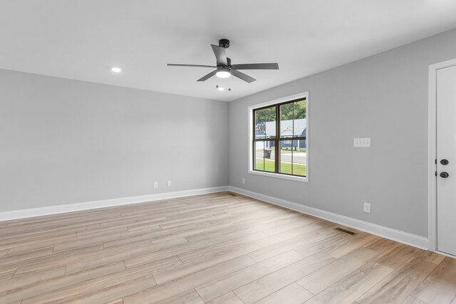 spare room featuring light hardwood / wood-style floors and ceiling fan